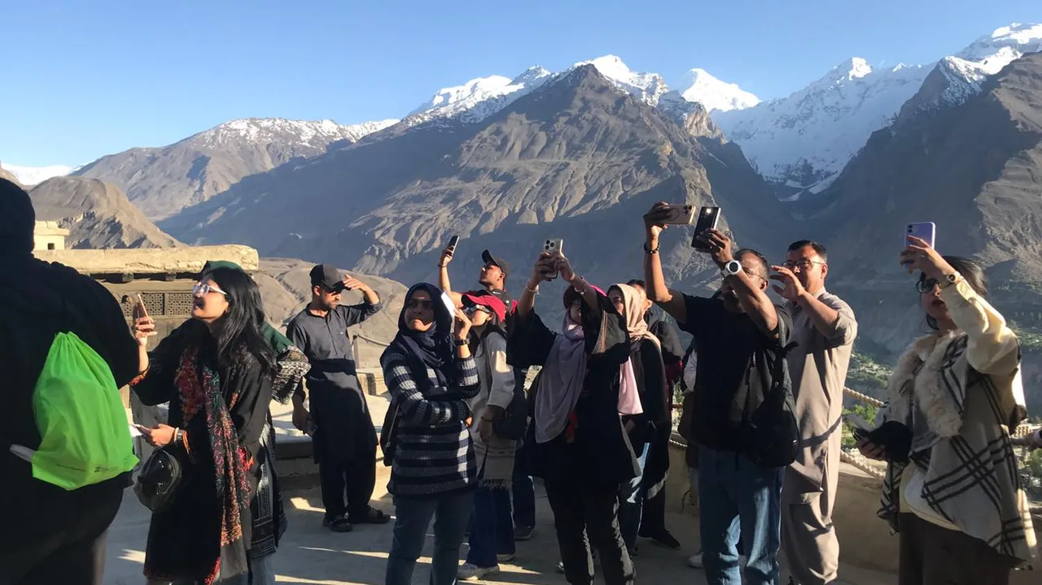 A group standing together in an open mountain valley