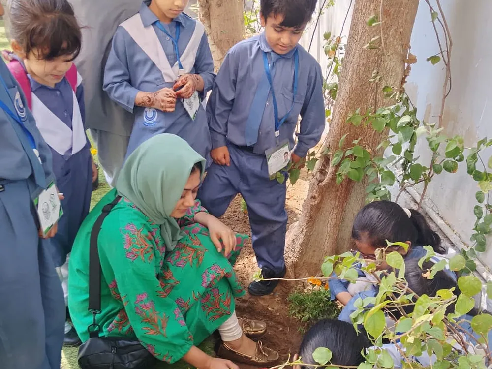 Schoolchildren Planting And Exploring Outdoors